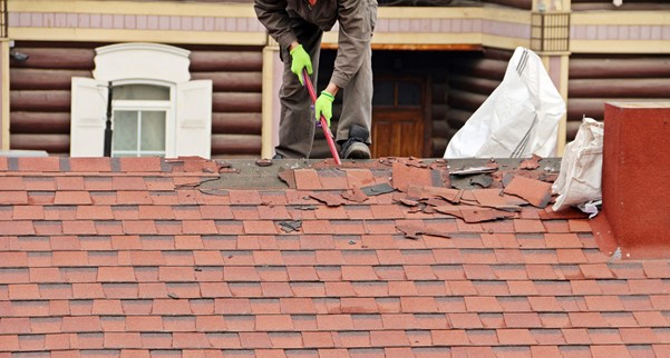 A Skabelund Roofing professional removing shingle roofs of a house in Cottonwood Heights, UT