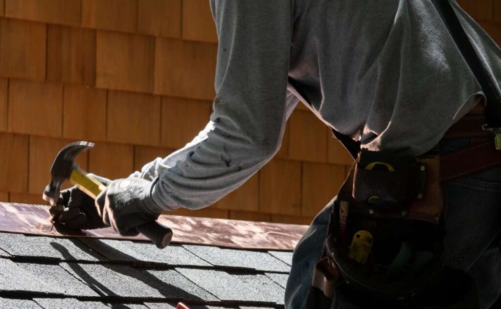 A professional installing a new roof of a house in Logan and Layton, UT
