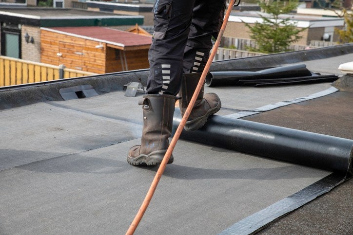 technician-installing-epdm-roof